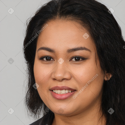 Joyful latino young-adult female with long  brown hair and brown eyes