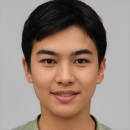 Joyful asian young-adult male with short  black hair and brown eyes