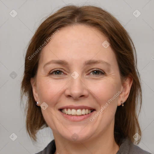 Joyful white adult female with medium  brown hair and blue eyes