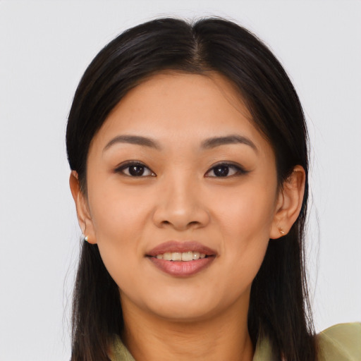 Joyful asian young-adult female with long  brown hair and brown eyes