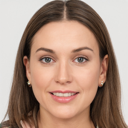 Joyful white young-adult female with long  brown hair and grey eyes