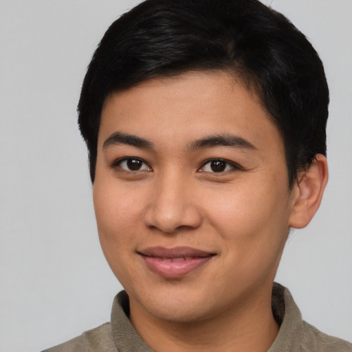Joyful asian young-adult male with short  brown hair and brown eyes