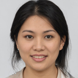 Joyful asian young-adult female with medium  brown hair and brown eyes