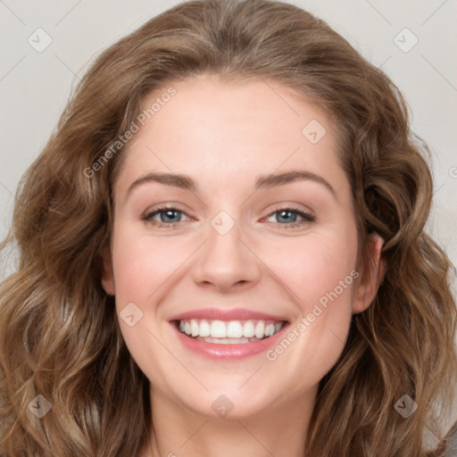 Joyful white young-adult female with long  brown hair and blue eyes