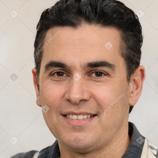 Joyful white adult male with short  brown hair and brown eyes