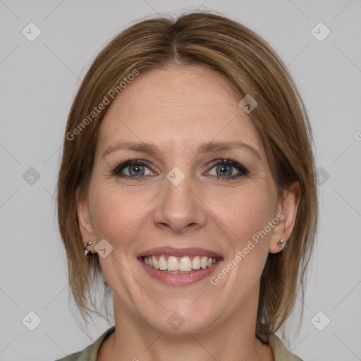 Joyful white adult female with medium  brown hair and grey eyes