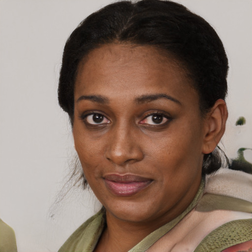 Joyful black young-adult female with medium  brown hair and brown eyes