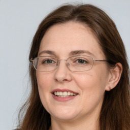 Joyful white adult female with long  brown hair and brown eyes