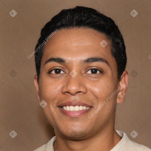 Joyful latino young-adult male with short  black hair and brown eyes