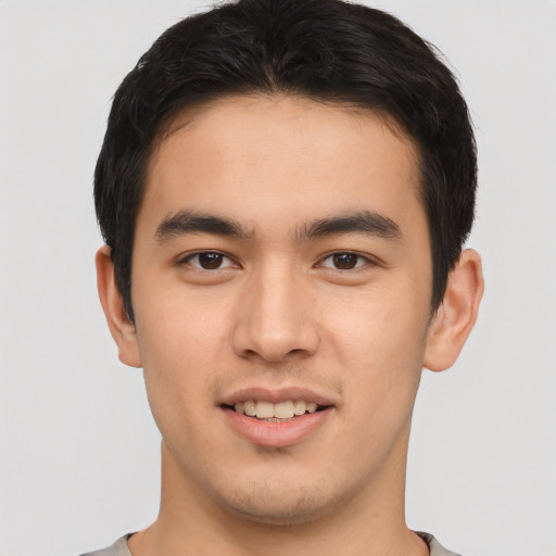 Joyful asian young-adult male with short  brown hair and brown eyes