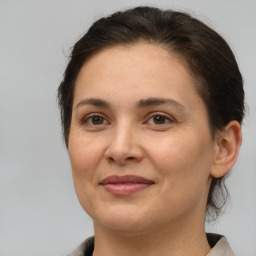 Joyful white adult female with medium  brown hair and brown eyes