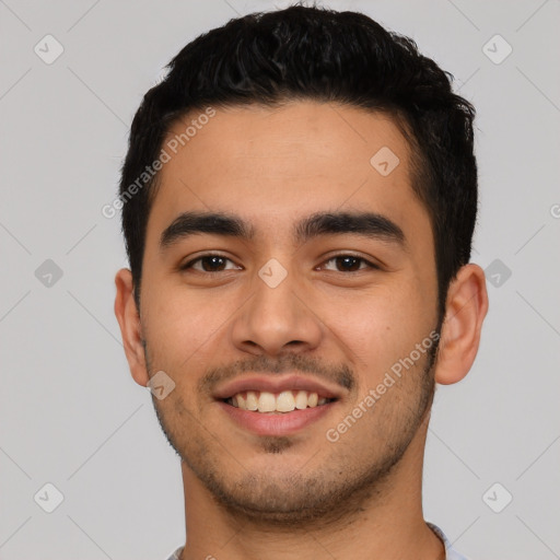 Joyful latino young-adult male with short  black hair and brown eyes