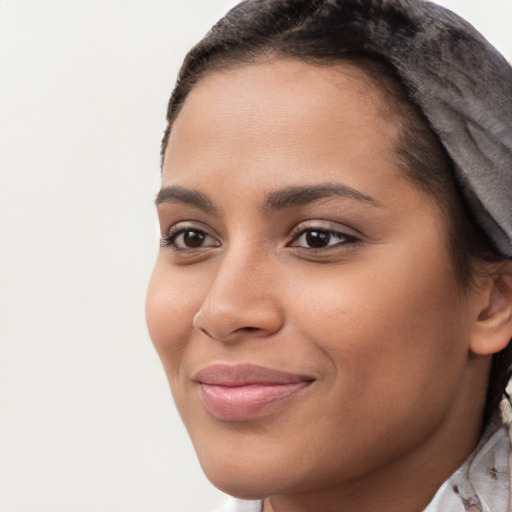 Joyful latino young-adult female with short  brown hair and brown eyes