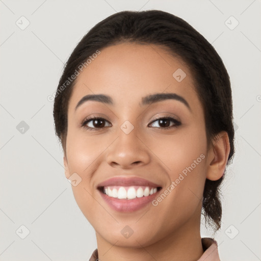 Joyful latino young-adult female with long  black hair and brown eyes