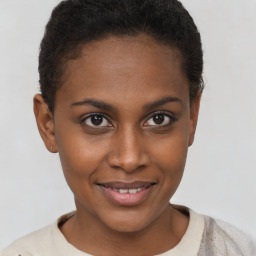 Joyful black young-adult female with short  brown hair and brown eyes