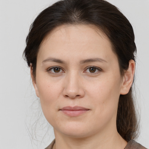 Joyful white young-adult female with medium  brown hair and brown eyes