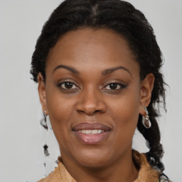 Joyful black adult female with medium  brown hair and brown eyes