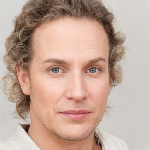 Joyful white young-adult male with short  brown hair and blue eyes