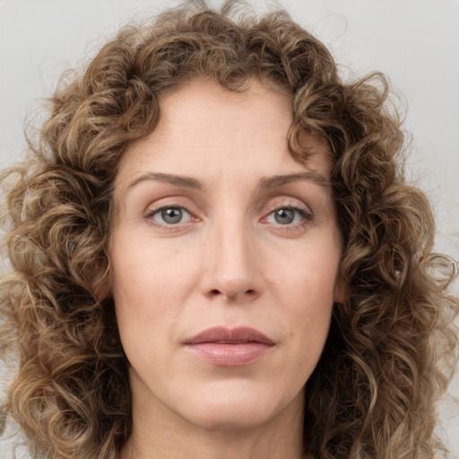 Joyful white young-adult female with long  brown hair and green eyes