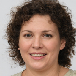 Joyful white adult female with medium  brown hair and brown eyes