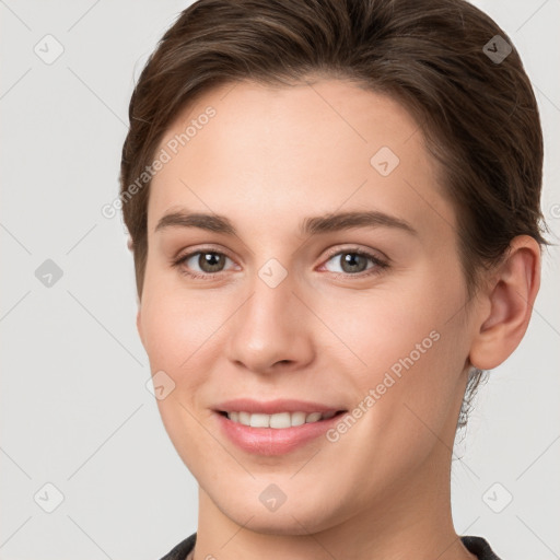 Joyful white young-adult female with short  brown hair and grey eyes