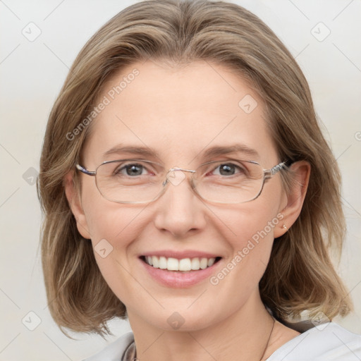 Joyful white adult female with medium  brown hair and blue eyes