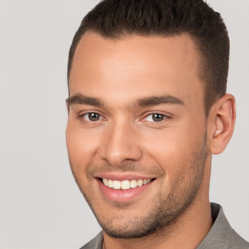 Joyful white young-adult male with short  brown hair and brown eyes