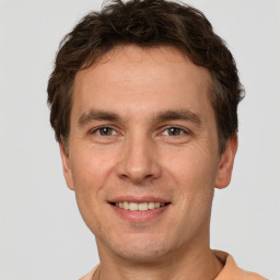 Joyful white adult male with short  brown hair and brown eyes