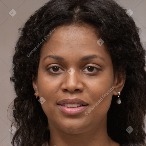 Joyful black young-adult female with long  brown hair and brown eyes