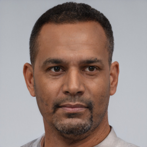 Neutral latino adult male with short  brown hair and brown eyes