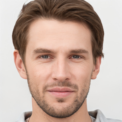 Joyful white young-adult male with short  brown hair and grey eyes