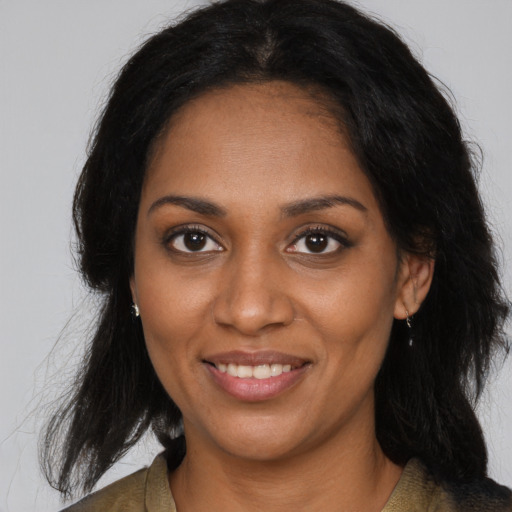 Joyful black young-adult female with medium  brown hair and brown eyes