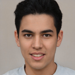 Joyful latino young-adult male with short  brown hair and brown eyes