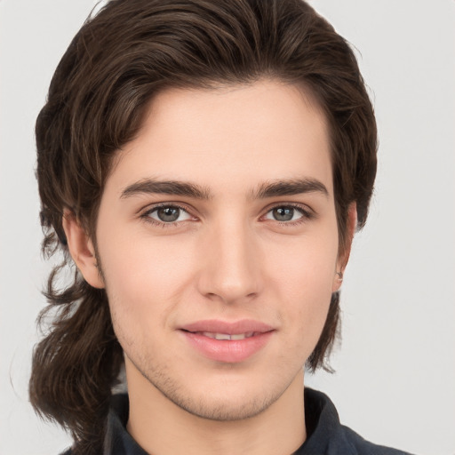 Joyful white young-adult male with medium  brown hair and brown eyes