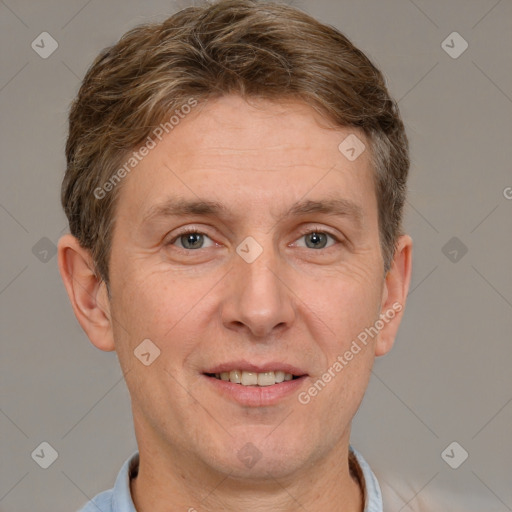 Joyful white adult male with short  brown hair and grey eyes