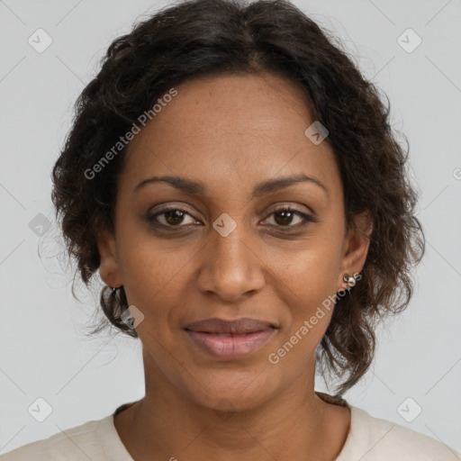 Joyful black adult female with medium  brown hair and brown eyes
