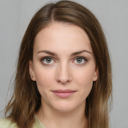 Joyful white young-adult female with long  brown hair and green eyes