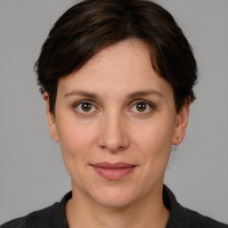 Joyful white adult female with short  brown hair and brown eyes