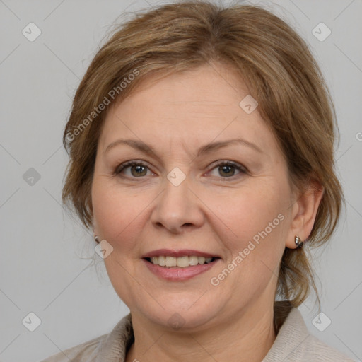 Joyful white adult female with medium  brown hair and grey eyes