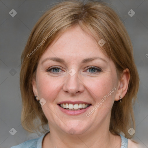 Joyful white adult female with medium  brown hair and blue eyes