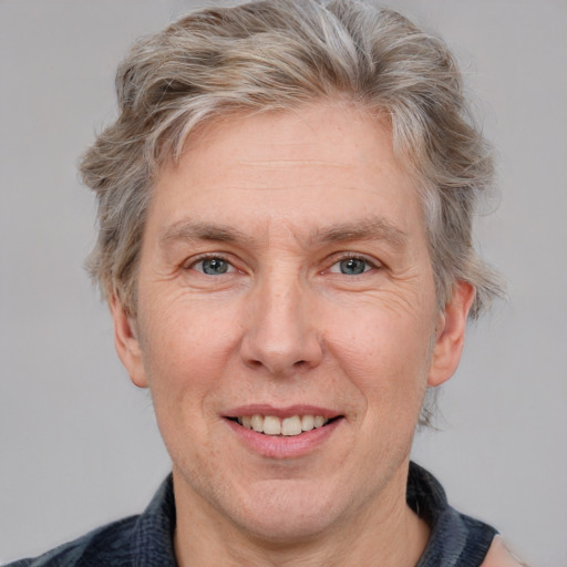 Joyful white adult male with short  brown hair and grey eyes