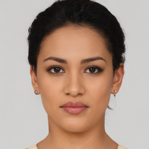 Joyful latino young-adult female with short  brown hair and brown eyes