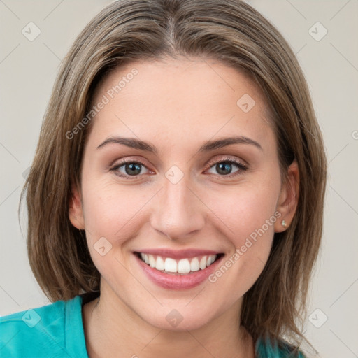 Joyful white young-adult female with medium  brown hair and blue eyes