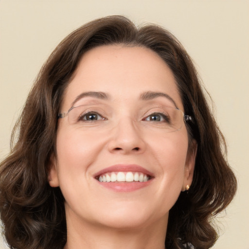 Joyful white young-adult female with medium  brown hair and green eyes