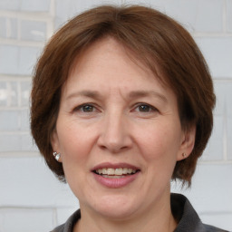 Joyful white adult female with medium  brown hair and brown eyes