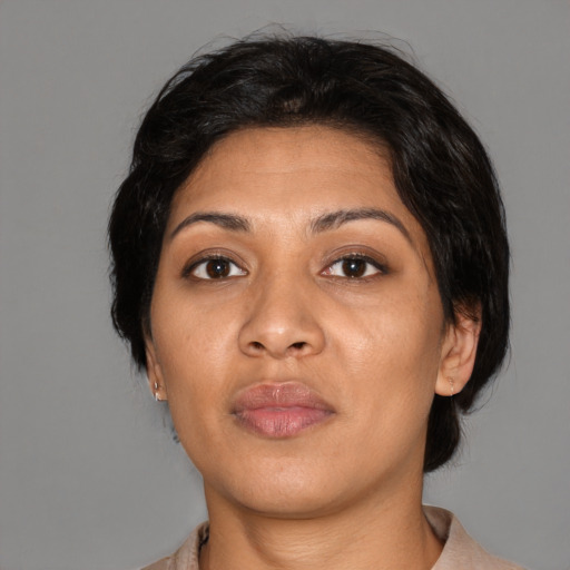 Neutral asian adult female with medium  brown hair and brown eyes