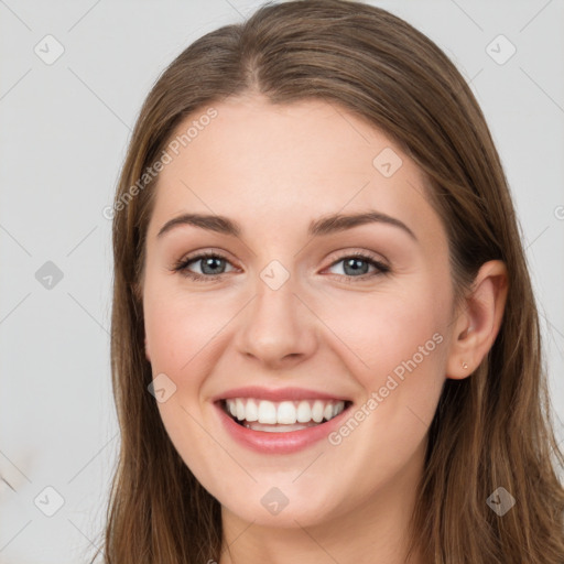 Joyful white young-adult female with long  brown hair and grey eyes