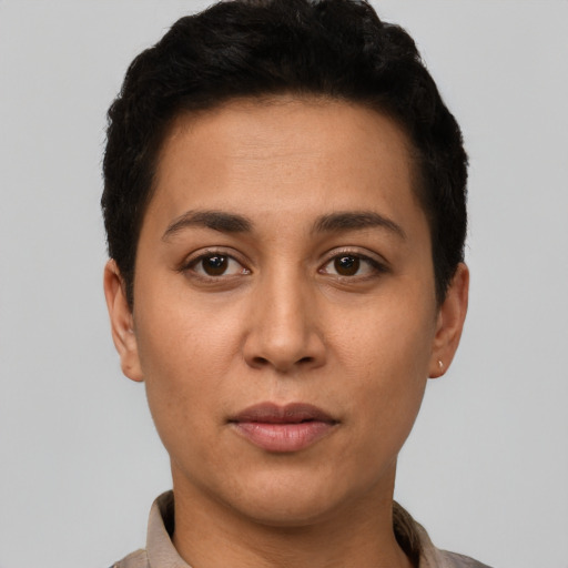 Joyful latino young-adult female with short  brown hair and brown eyes