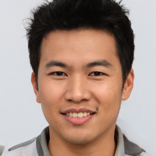 Joyful asian young-adult male with short  brown hair and brown eyes