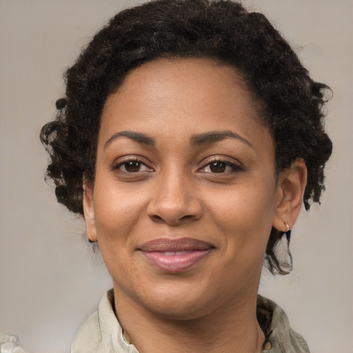 Joyful black adult female with medium  brown hair and brown eyes